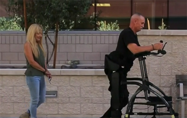 A veteran with a spinal cord injury using a SoldierStrong exoskeleton to walk.