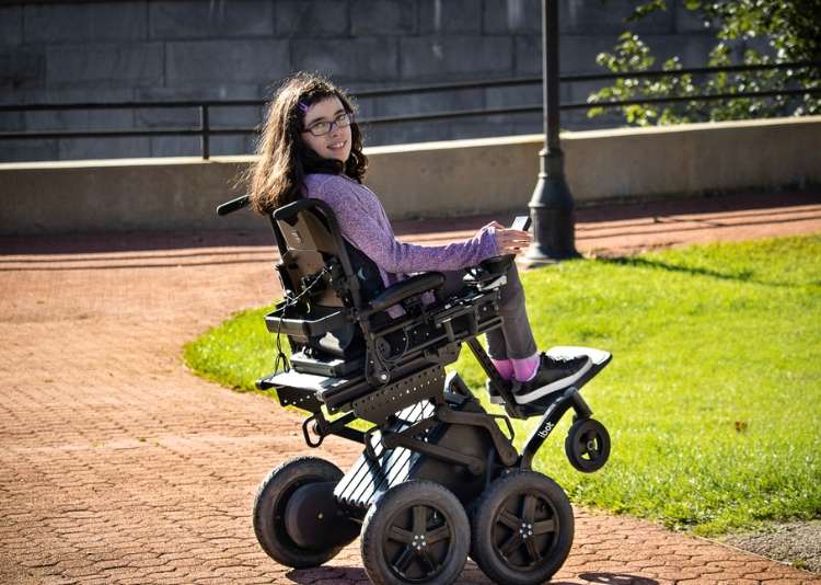 Woman-in-iBOT-chair-on-brick-path.